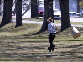 Max Delmar runs through Jeanne-Mance Park trying to fly a paper bag kite in Montreal, on Tuesday, April 6, 2021.
