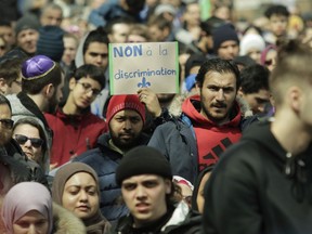 A man holds a sign in Place Émilie-Gamelin in Montreal Sunday, April 7, 2019 to denounce the Quebec government's Bill 21.