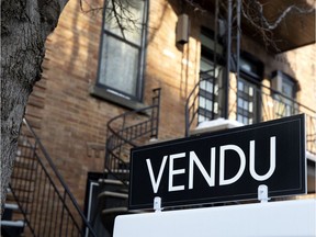 A for sale sign on a residential property in Montreal.