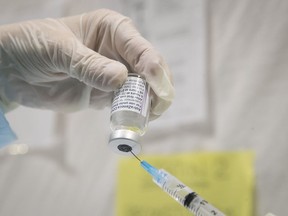 The AstraZeneca vaccine is filled into syringe on Thursday April 8, 2021 at the Bill Durnan arena during the COVID-19 pandemic. (Pierre Obendrauf / MONTREAL GAZETTE) ORG XMIT: 65986 - 7510