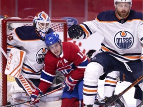 Montreal Canadiens right-wing Brendan Gallagher crashes into Edmonton Oilers goaltender Mikko Koskinen after taking a hit from Edmonton Oilers defenceman Adam Larsson in Montreal on March 30, 2021.