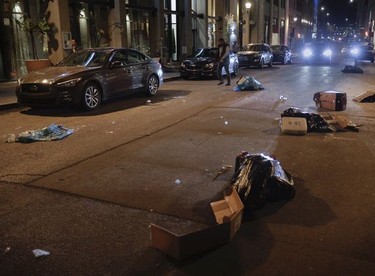 Garbage strewn on Notre-Dame St. West  in Old Montreal on April 11, 2021, after a crowd of at least several hundred people gathered at the Old Port, chanting and shooting off fireworks to protest the return to an 8 p.m. curfew in Montreal.
