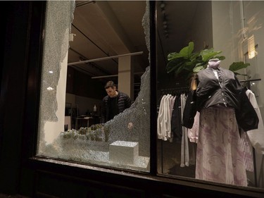 Alex Danino, owner of a clothes store called Rooney Shop in Old Montreal surveys damage made when a crowd gathered to protest an 8 p.m. curfew.