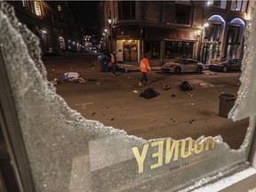 Workers survey the damage outside Rooney shop on Notre-Dame St. in Old Montreal on Sunday.