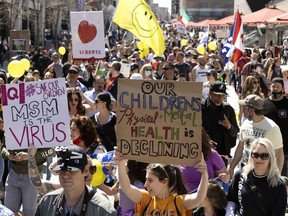 A large crowd of mostly maskless people protest against COVID-19 health measures in Montreal on Saturday, April 10, 2021.