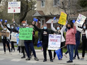 Teachers from Lakeside Academy high school and Maple Grove elementary school look for support from passing motorists at 55th Ave. and Victoria St. in  Lachine on April 14 during limited strike action.