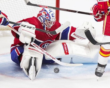 Jake Allen keeps his eyes on the puck between his legs during second period at the Bell Centre in Montreal on Wednesday, April 14, 2021.