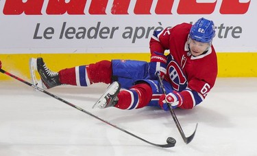 Artturi Lehkonen plays the puck while sitting on the ice during third period at the Bell Centre in Montreal on Wednesday, April 14, 2021.
