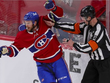 Brett Kulak runs into referee Eric Furlatt after scoring a goal against the Calgary Flames during second period at the Bell Centre in Montreal on Wednesday April 14, 2021.