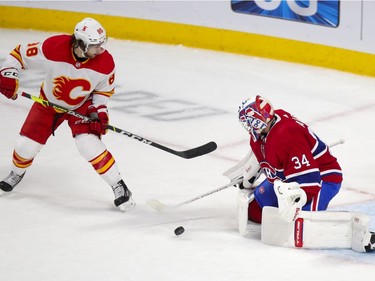 Jake Allen makes a save as Andrew Mangiapane looks for the rebound during first period at the Bell Centre in Montreal on Wednesday April 14, 2021.