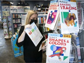 Sylvie Calder arranges a display at the Librairie Clio bookstore located in the Pointe-Claire Plaza.