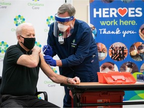 Ric Cumings, a John Abbott College nursing graduate, vaccinated Joe Biden (left) at a medical facility in Newark, Delaware, on Jan. 11, 2021.