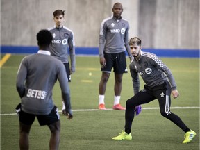 CF Montréal midfielder Emanuel Maciel (25), right, runs drills with his teammates as they  take part in training camp in Montreal on March 17, 2021.