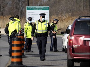 OPP officers man road checks at the Quebec/Ontario border, which has been mostly closed because of pandemic health rules.