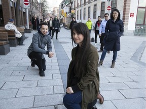 Karen Cho, foreground, and Jonathan Cha, left, with members of the Chinatown Working Group, are seen at the corner of de la Gauchetière and Côté Sts. in the heart of Montreal's Chinatown on Friday, April 23, 2021.