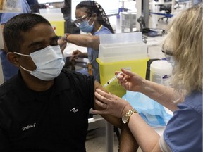 A CAE employee receives an AstraZeneca  Covid-19 vaccination at the company-sponsored Covid-19 centre in Montreal, on Monday, April 26, 2021.