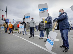 Longshoreman picket at the entrance to the Port of Montreal at Viau St. on Monday.