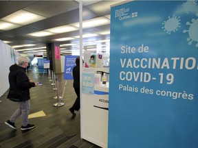 A woman arrives for her COVID-19 vaccination appointment at the Palais des Congrès in Montreal on April 27, 2021.