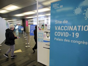 A woman arrives for her COVID-19 vaccination appointment at the Palais des congrès in Montreal on Tuesday April 27, 2021.