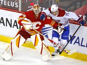 Calgary Flames goalie Jacob Markstrom battles Montreal Canadiens' Jake Evans during third period at the Scotiabank Saddledome in Calgary on April 26, 2021.