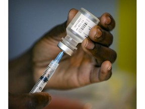 A syringe is loaded with the Pfizer vaccine at a vaccination clinic organized by the Resilience Montreal day shelter in Montreal Wednesday April 28, 2021.