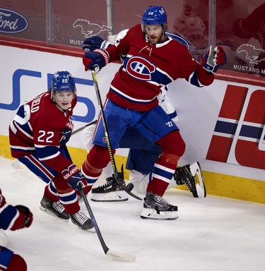 Habs right wing Cole Caufield plays the puck as defenseman Jon Merrill (holds back Toronto Maple Leafs centre Jason Spezza during first-period action in Montreal on Wednesday, April 28, 2021.