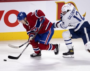 Habs centre Nick Suzuki holds off Toronto Maple Leafs centre Alex Galchenyuk during first-period action in Montreal on Wednesday, April 28, 2021.