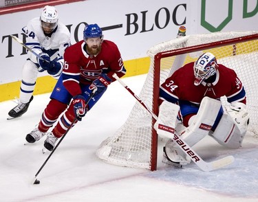 Toronto Maple Leafs right wing Wayne Simmonds pressures Habs defenseman Jeff Petry as he rounds goaltender Jake Allen's  net during second-period action in Montreal on Wednesday, April 28, 2021.