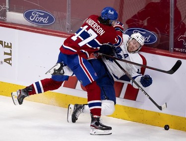 Habs right wing Josh Anderson drives Toronto Maple Leafs defenseman Morgan Rielly to the ice during second-period action in Montreal on Wednesday, April 28, 2021.