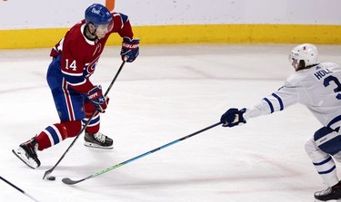 Despite pressure from Toronto Maple Leafs defenseman Justin Holl, Habs centre Nick Suzuki scores on goaltender Jack Campbell during second-period action in Montreal on Wednesday, April 28, 2021.