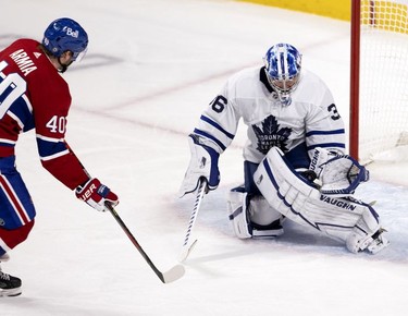 Toronto Maple Leafs goaltender Jack Campbell traps the puck between his glove and pads as he shuts down Habs right wing Joel Armia's breakaway during second-period action in Montreal on Wednesday, April 28, 2021.