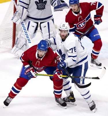 Habs centre Eric Staal is in the thick of it with Toronto Maple Leafs defenseman T.J. Brodie as Habs centre Jake Evans looks on during third-period action in Montreal on Wednesday, April 28, 2021.