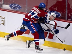 Habs right wing Josh Anderson drives Toronto Maple Leafs defenseman Morgan Rielly to the ice during third-period action in Montreal on Wednesday, April 28, 2021.