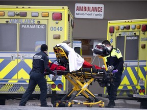 Paramedics transfer a patient to the St. Mary's ER. Despite the COVID outbreak, nurses and other staff are working through their lunch breaks to ensure that all ER patients are seen.