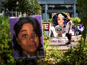 A man pauses at the memorial of Breonna Taylor before a march, after a grand jury decided not to bring homicide charges against police officers involved in the fatal shooting of Taylor in her apartment, in Louisville, Kentucky, September 25, 2020.