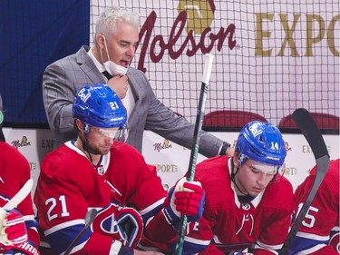 Coach Dominique Ducharme speaks to Nick Suzuki, right, on the bench during the third period at the Bell Centre in Montreal on Thursday, April 8, 2021.