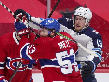 Winnipeg Jets' Pierre-Luc Dubois wraps his stick around Victor Mete's head during second period at the Bell Centre in Montreal on Thursday, April 8, 2021.