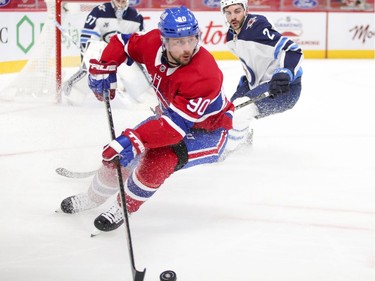 Tomas Tatar controls the puck in front of Winnipeg Jets' Dylan DeMelo during the third period at the Bell Centre in Montreal on Thursday, April 8, 2021.