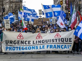 A demonstration by le Movement des jeunes souverainistes protesting against government funding of infrastructure projects at Dawson College and McGill University makes its way from Old Montreal to McGill's downtown campus on  Nov. 28, 2020.