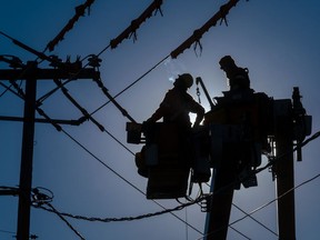 Hydro-Québec workers at a power line.