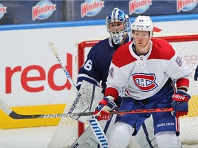 Canadiens forward Corey Perry keeps his eye on the puck while standing in front of Maple Leafs goalie Jack Campbell during Wednesday night’s game in Toronto.