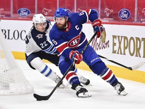 Canadiens defenceman Shea Weber (6) skates the puck against Mason Appleton of the Winnipeg Jets during the third period at the Bell Centre on Saturday, April 10, 2021, in Montreal.