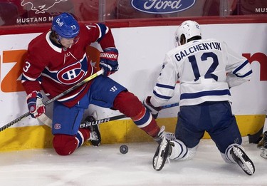 Both on their knees, Habs right wing Tyler Toffoli and Toronto Maple Leafs centre Alex Galchenyuk battle for the puck during first-period action in Montreal on Wednesday, April 28, 2021.