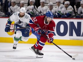 Montreal Canadiens' Jonathan Drouin (92) carries the puck over the blue line as Vancouver Canucks defenceman Jordie Benn (8) follows behind Feb. 1, 2021.