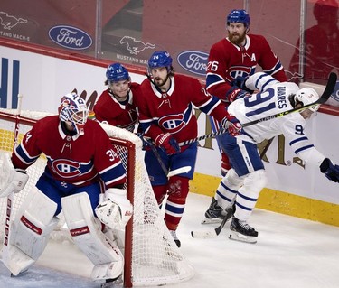 It gets crowded behind Habs goaltender Jake Allen's net as Habs right wing Cole Caufield, left to right, left wing Phillip Danault and defenseman Jeff Petry all get tied up by Toronto Maple Leafs centre John Tavares during third-period action in Montreal on Wednesday, April 28, 2021.