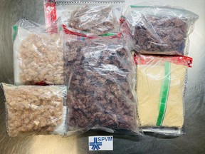 A photo supplied by Montreal police shows packages of fentanyl seized worth about $1.4 million, the largest such seizure in Quebec history. Curtis Harris, 37, Eddwich Simon, 34, and Jamall McKenzie, 40, face charges in connection with the seizure.