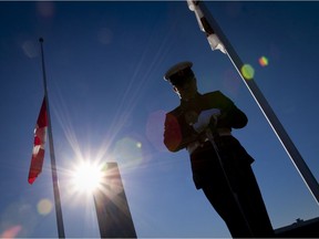 A soldier stands guard by a monument during the Remembrance Day ceremony at CFB Valcartier in 2010.