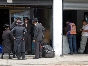 Members of the ultra-Orthodox Lev Tahor Jewish group are seen at the entrance of a building in Guatemala City, where the group has been residing.