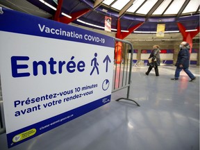 A couple arrive for their appointments at the Covid-19 vaccination centre at the Olympic Stadium in Montreal Monday April 5, 2021.