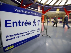 A couple arrive for their appointments at the Covid-19 vaccination centre at the Olympic Stadium in Montreal Monday April 5, 2021. Some 5,000 vaccination appointments went unfilled Easter weekend.